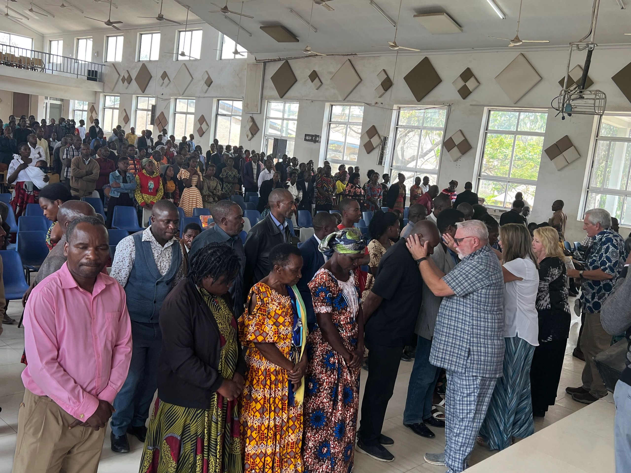 Mike praying over believers at a church gathering in Tanzania