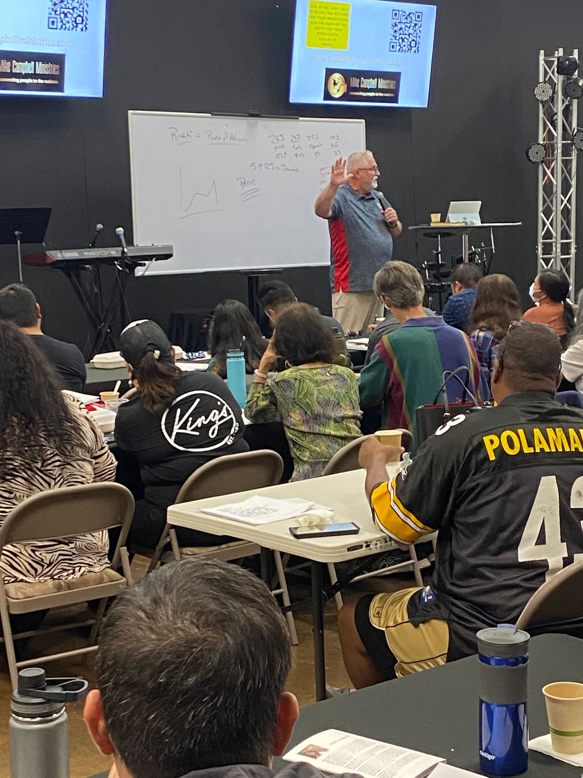 Mike Campbell leading a financial seminar at a whiteboard